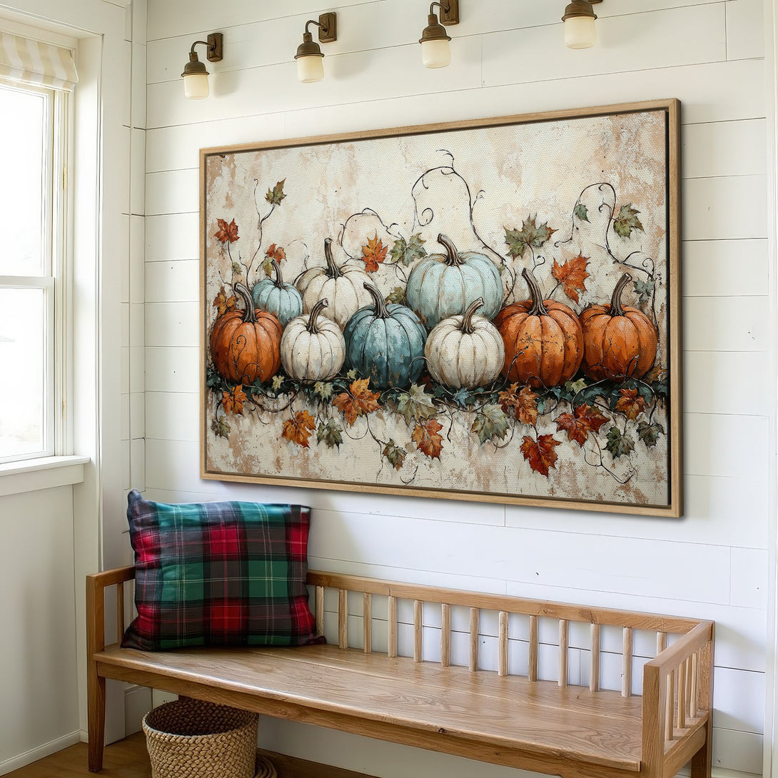 Framed Wall Art featuring a rustic pumpkin painting in warm orange, white, and teal hues. Perfect fall decor for a cozy farmhouse style home.