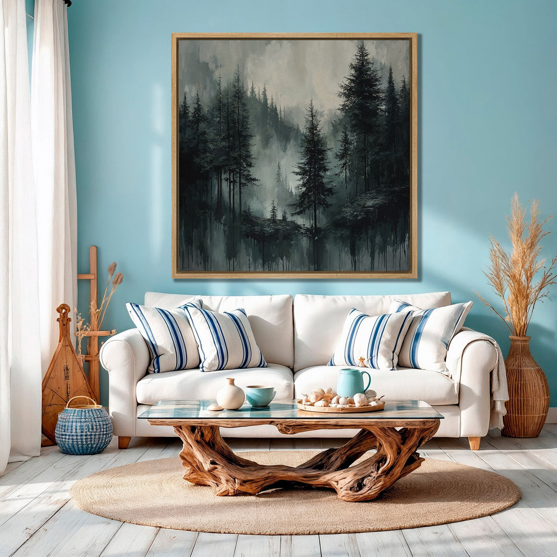 Framed Wall Art of a moody forest scene in grayscale tones. Modern canvas print adds a touch of nature to a coastal-inspired living room.