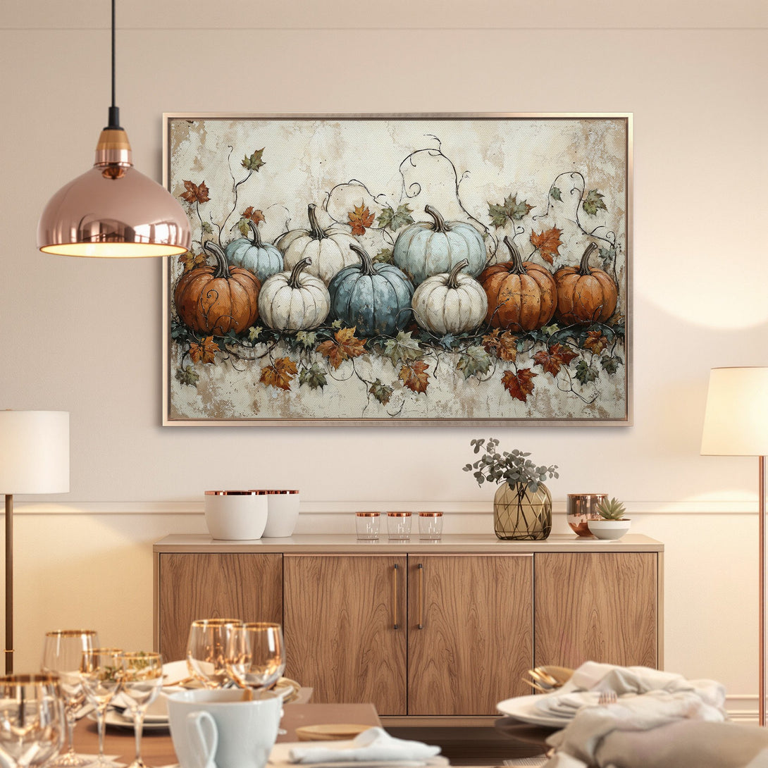 Framed Wall Art: Autumn pumpkins in warm orange, teal, and cream hues. Rustic style canvas print adds cozy fall decor to any room.