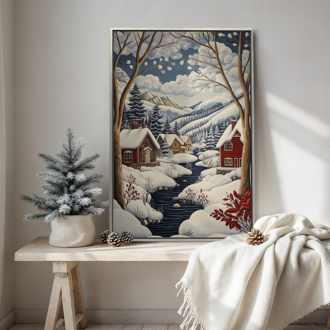 Framed Wall Art: Winter village scene in a whimsical style with red houses, snow, and blue sky. Perfect for cozy home decor.