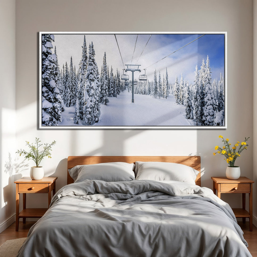 Framed Wall Art Canvas Print of snowy ski resort scene with blue sky. Winter landscape art in a bedroom, featuring white, blue, and gray tones.