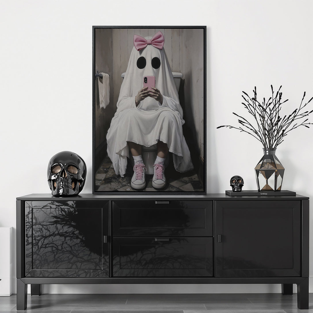 Framed Wall Art featuring a ghost in a pink bow using a phone. Modern, humorous art in neutral and pink tones. Perfect for Halloween decor.