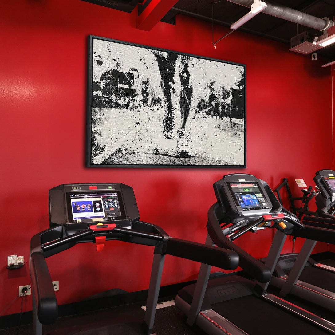 Framed Wall Art: Abstract black and white running figure canvas print in a red gym setting. Modern art for home or office decor.