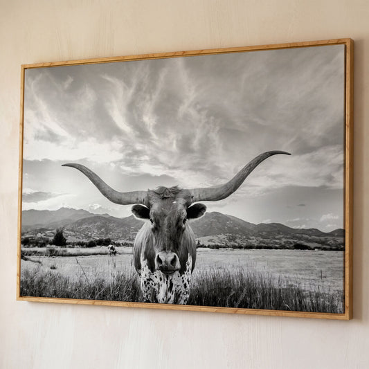Texas Longhorn Portrait Canvas Wall Art, Mountain Sky Background shown in white oak floating frame