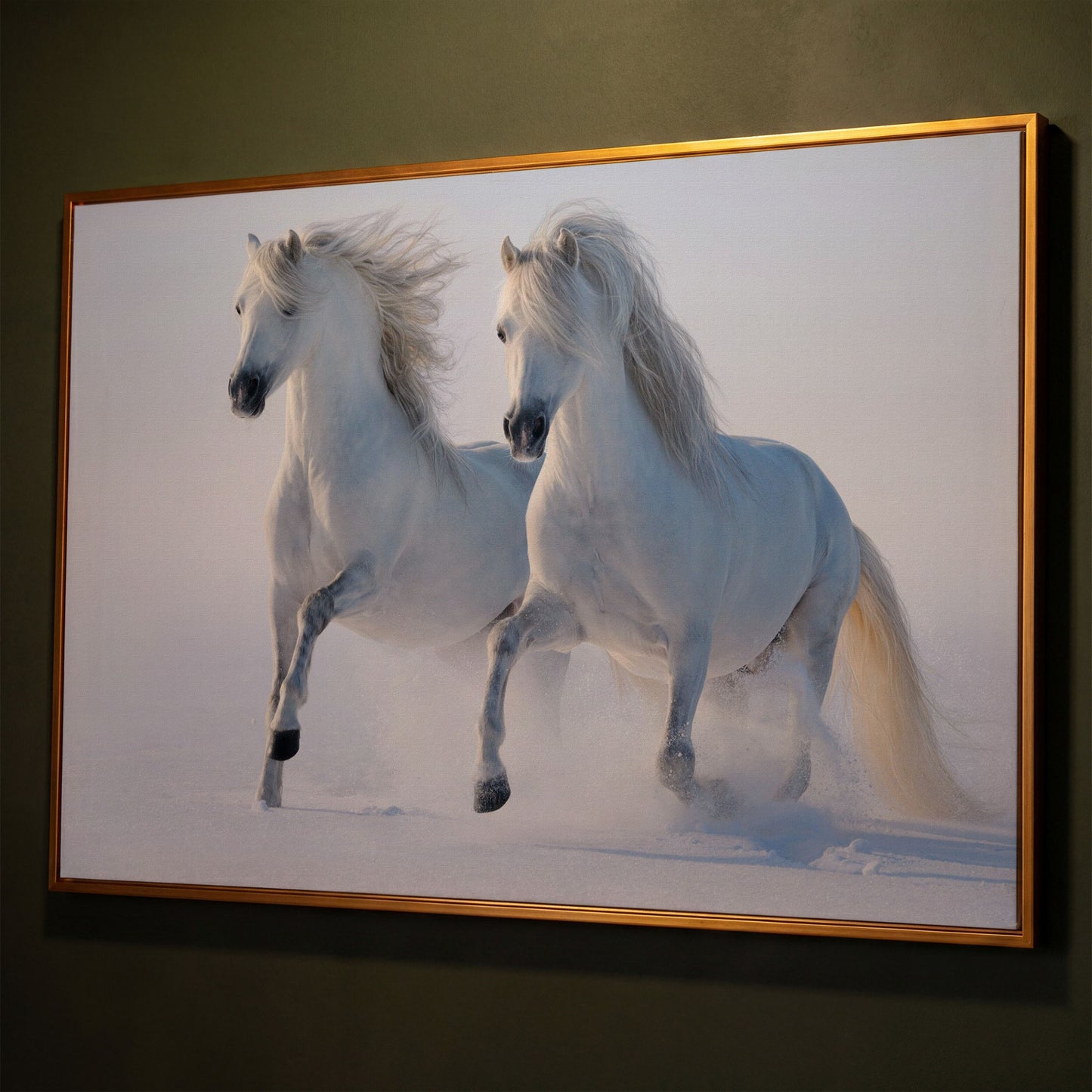 Two White Horses Running Through Snow. Canvas Wall Art shown in antique gold floating frame