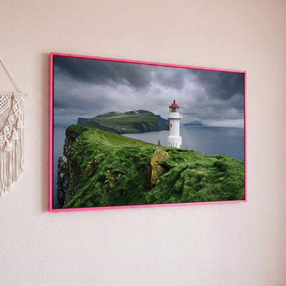 White Lighthouse on a Stormy Cliff, Coastal Canvas Wall Art in pink floating frame