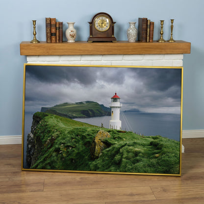 White Lighthouse on a Stormy Cliff, Coastal Canvas Wall Art in yellow gold floating frame