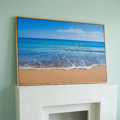 Calm Shore: Panoramic Beach Canvas Wall Art in white oak floating frame