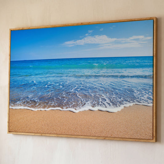 Calm Shore: Panoramic Beach Canvas Wall Art shown in white oak floating frame