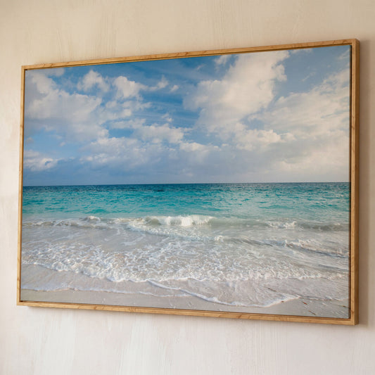 Calm Ocean Shore Canvas Art, Coastal Seascape Wall Print shown in white oak floating frame