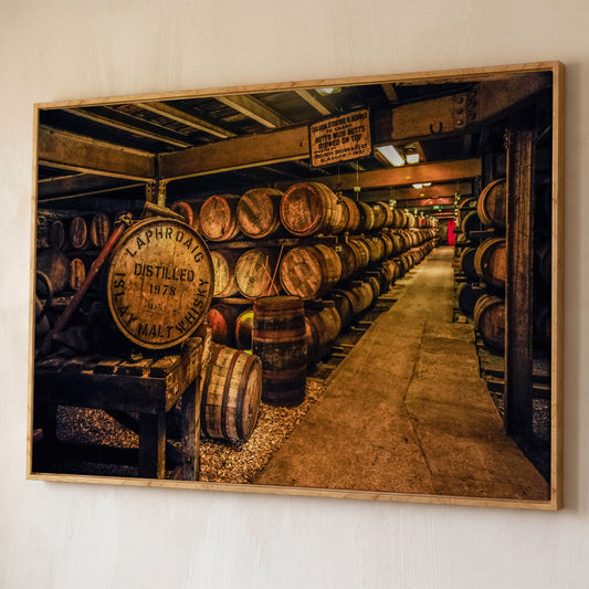 Laphroaig Distillery Barrel Rows Canvas Wall Art shown in white oak floating frame