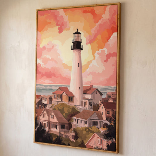 Coastal Village Lighthouse Canvas Art, Warm Sky Tones shown in white oak floating frame