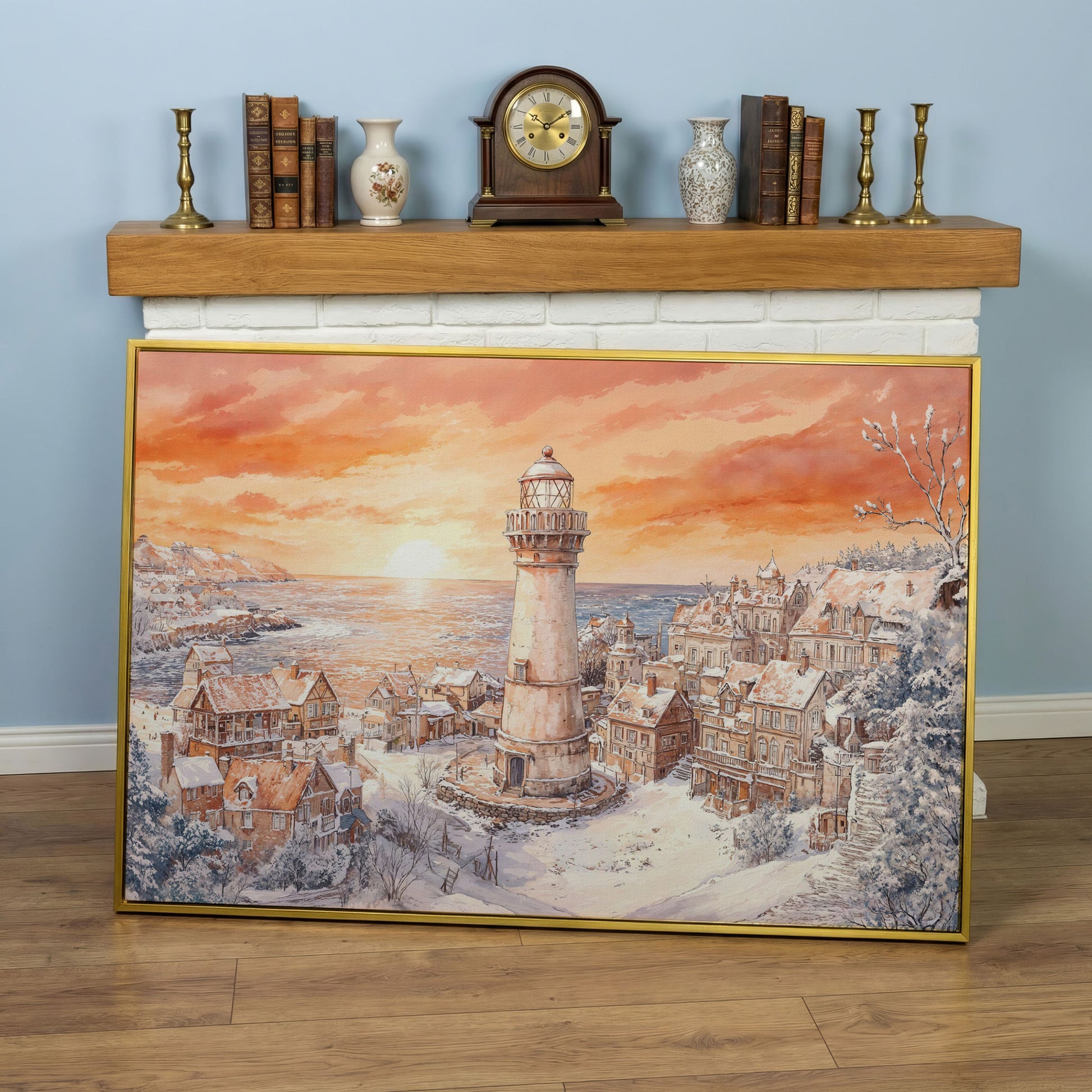 Snowy Coastal Village with Lighthouse at Sunrise Canvas Art in yellow gold floating frame