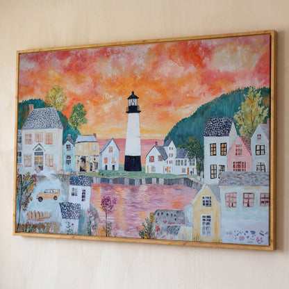 Lighthouse Village at Sunset Canvas Wall Art shown in white oak floating frame