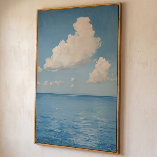White Clouds and Calm Blue Sea Canvas shown in white oak floating frame