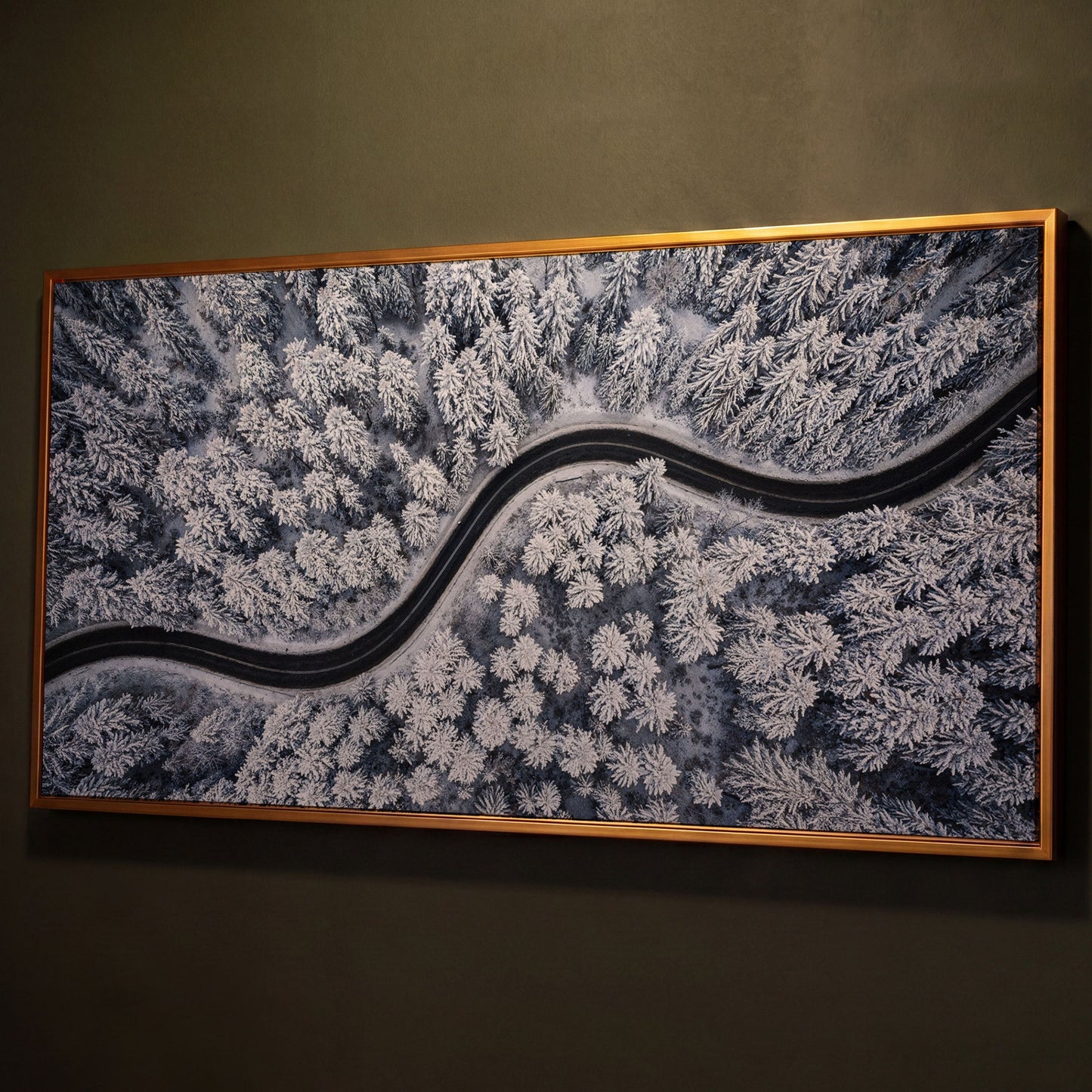 Curvy Winter Road in Snowy Forest Canvas shown in antique gold floating frame