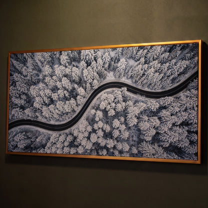 Curvy Winter Road in Snowy Forest Canvas shown in antique gold floating frame