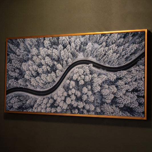 Curvy Winter Road in Snowy Forest Canvas shown in antique gold floating frame