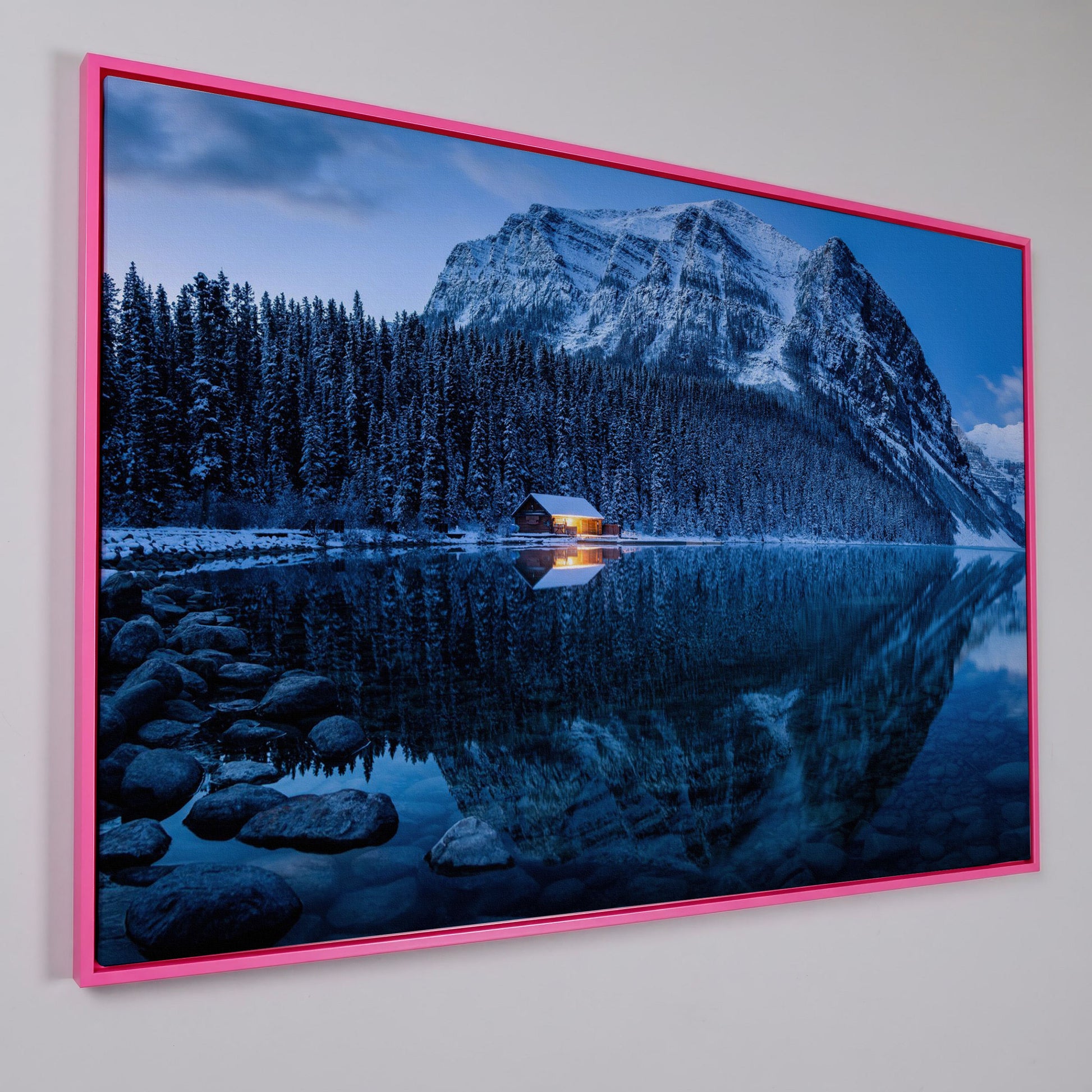 Lake Louise Winter Canvas with Lit Cabin and Mountain Reflection in pink floating frame