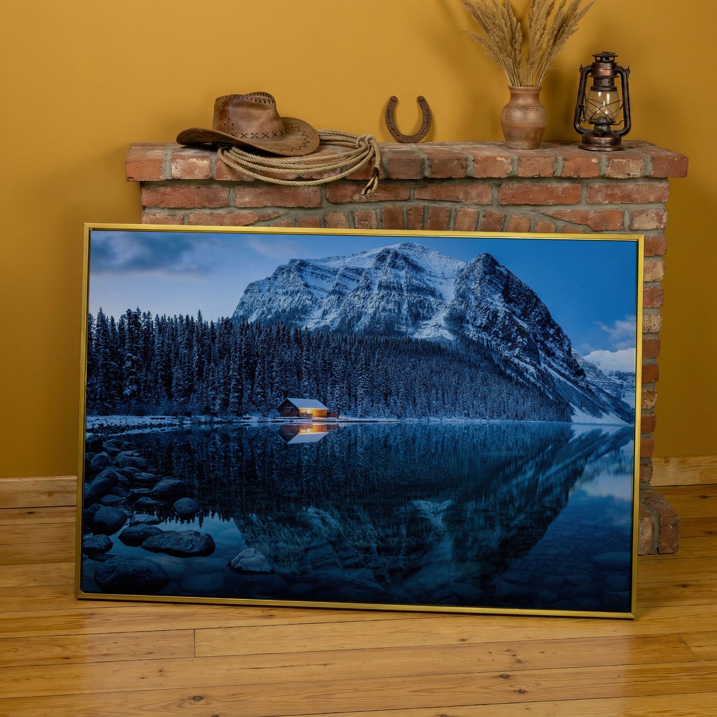 Lake Louise Winter Canvas with Lit Cabin and Mountain Reflection in yellow gold floating frame