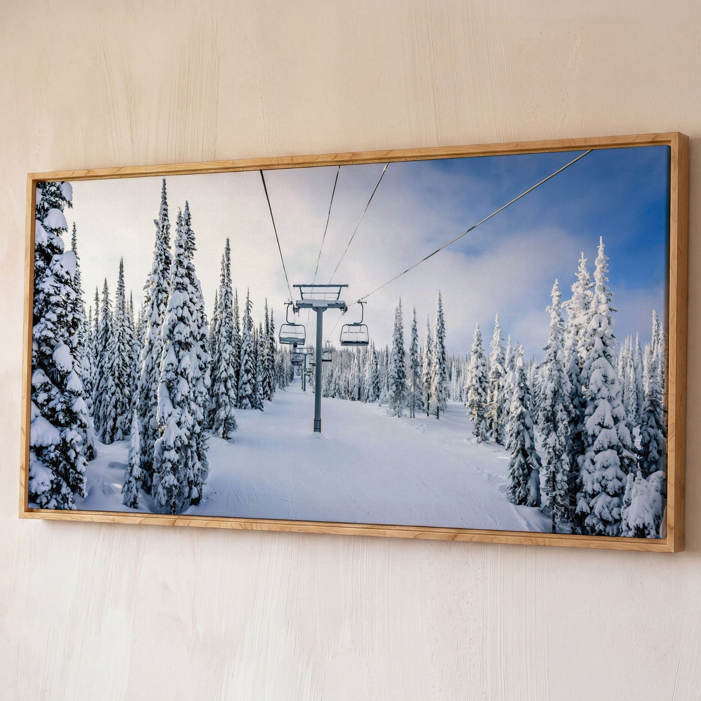 Snowy Ski Lift and Pine Trees Canvas shown in white oak floating frame