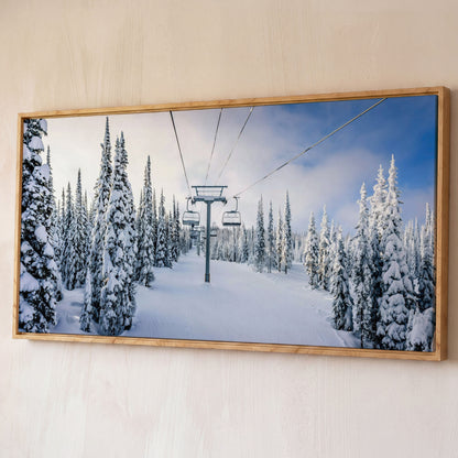 Snowy Ski Lift and Pine Trees Canvas shown in white oak floating frame
