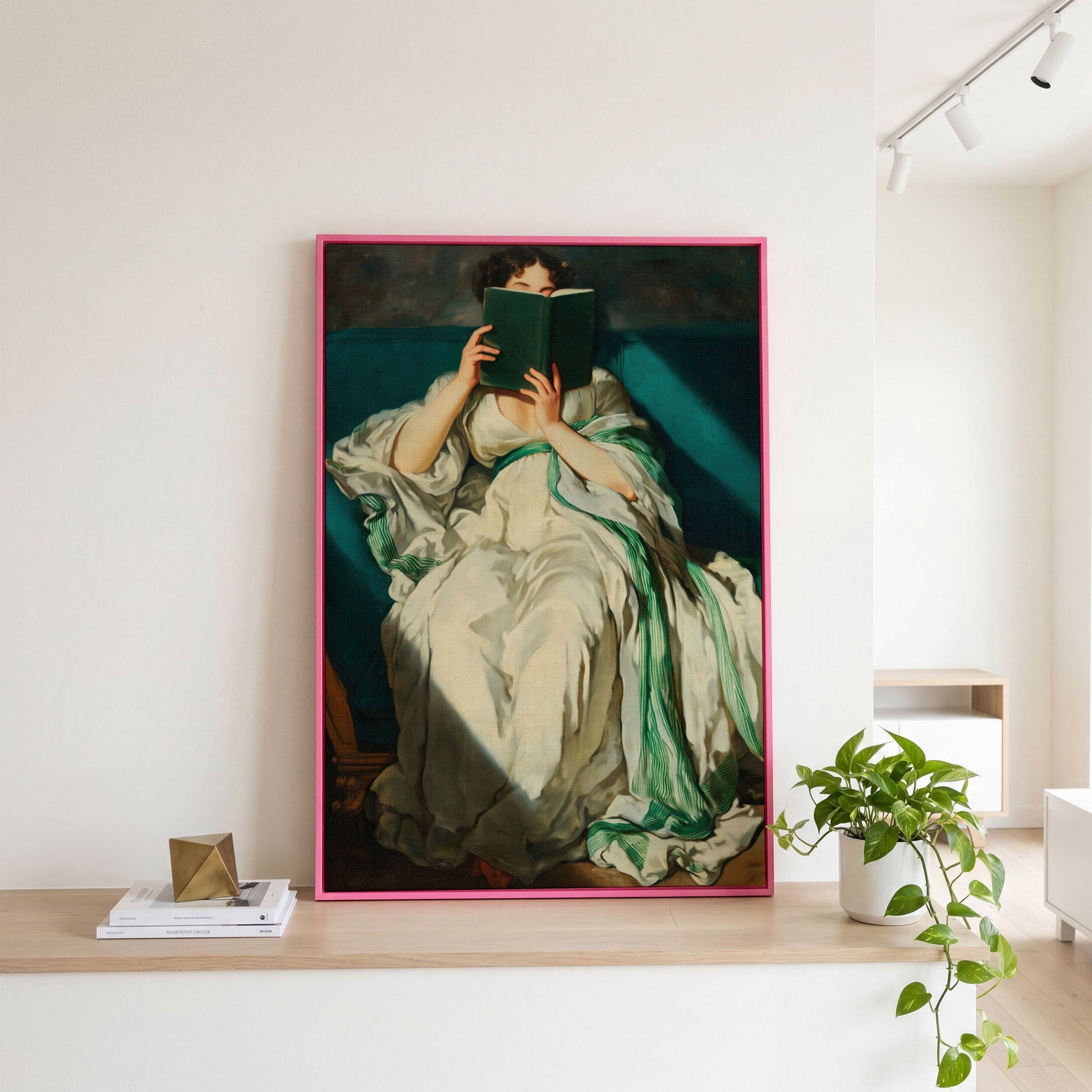 Woman Reading on a Turquoise Sofa. Canvas Wall Art for Book Lovers in pink floating frame