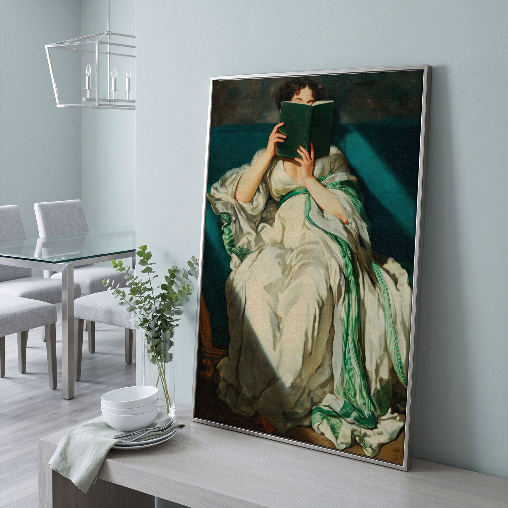 Woman Reading on a Turquoise Sofa. Canvas Wall Art for Book Lovers in silver floating frame