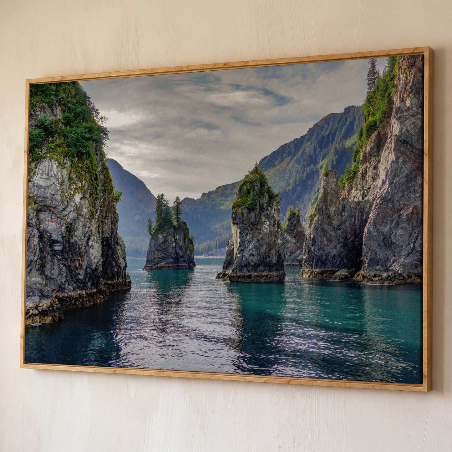 Turquoise Water and Rock Spires Panoramic Canvas shown in white oak floating frame