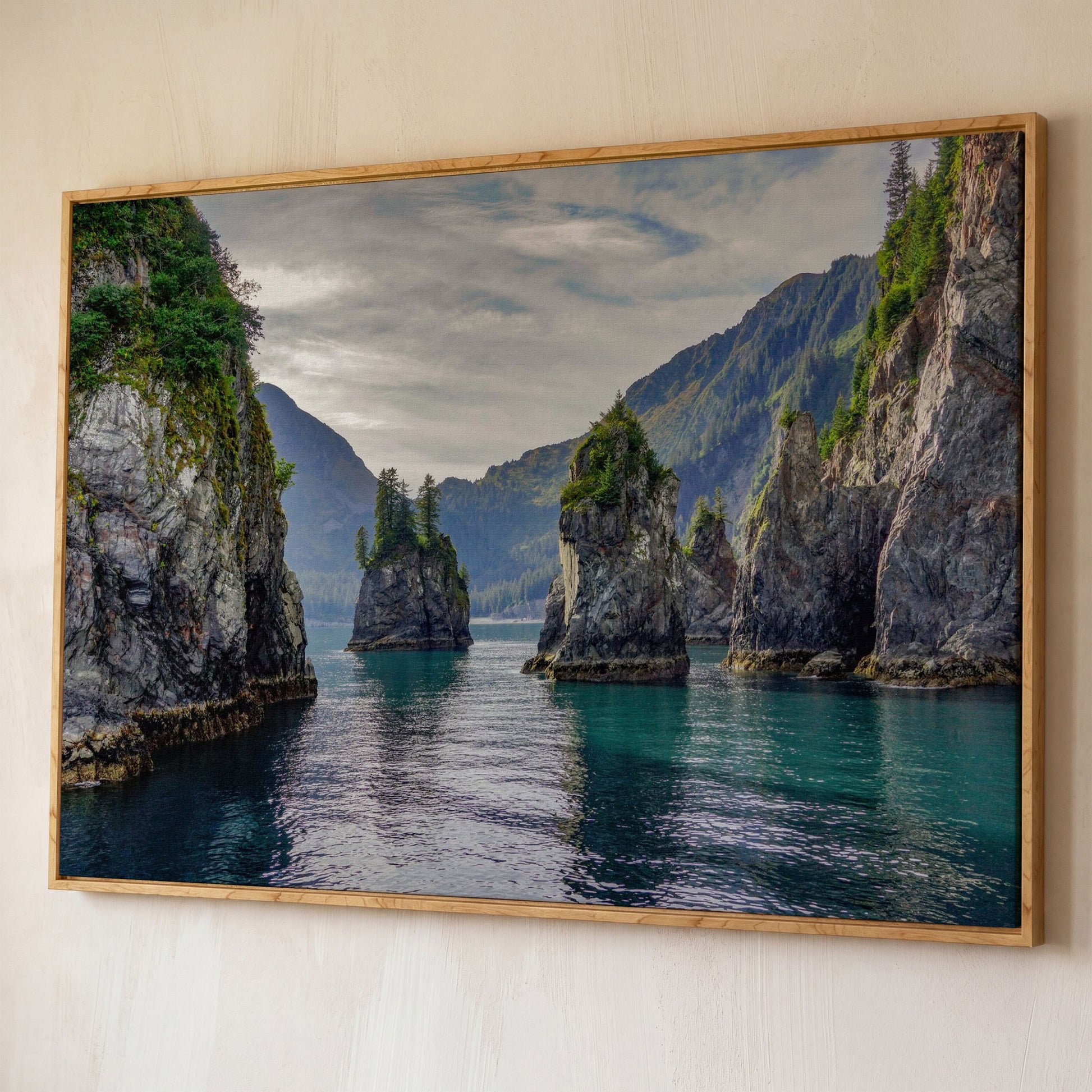 Turquoise Water and Rock Spires Panoramic Canvas shown in white oak floating frame