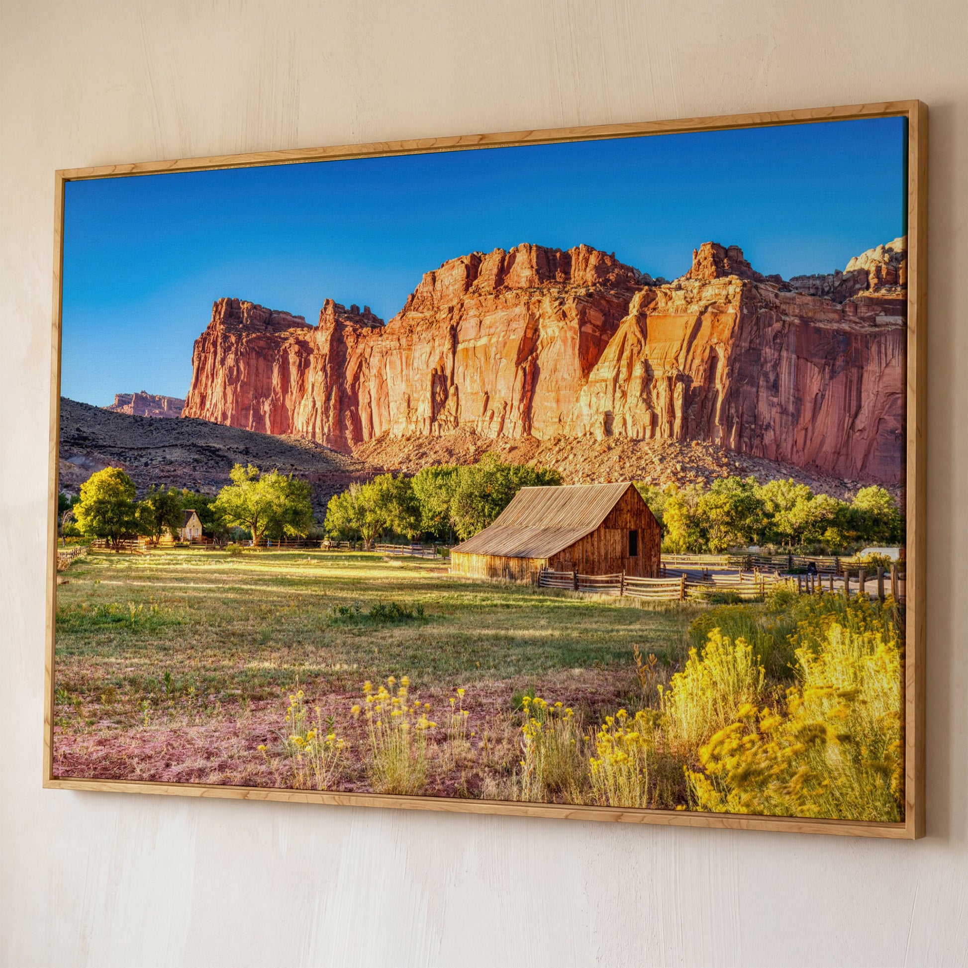 Fruita Barn with Red Rock Cliffs Canvas shown in white oak floating frame