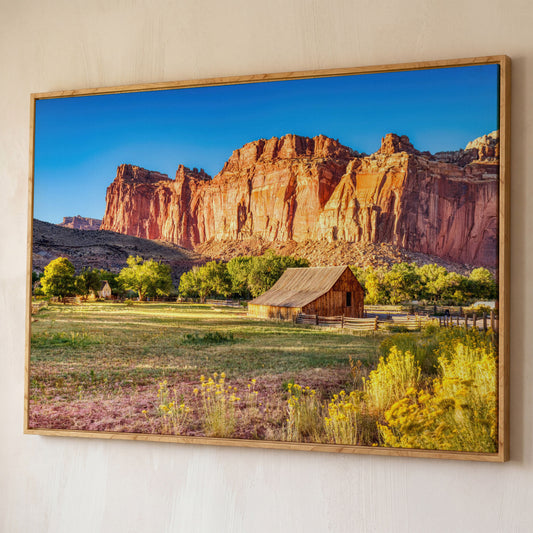 Fruita Barn with Red Rock Cliffs Canvas shown in white oak floating frame
