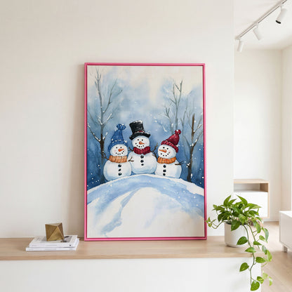 Three Snowmen on a Hill Canvas Print in pink floating frame