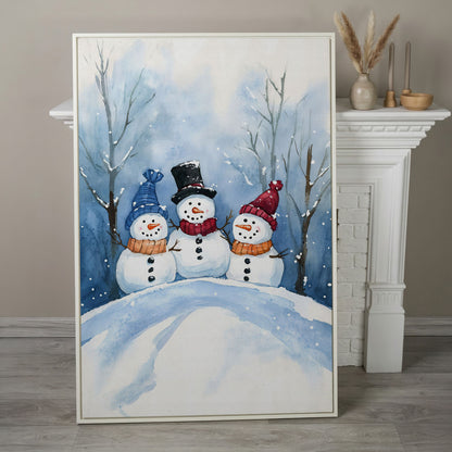 Three Snowmen on a Hill Canvas Print in white floating frame