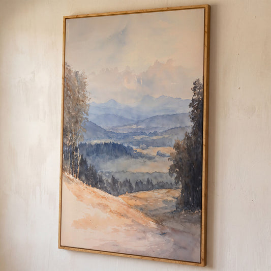 Serene Mountain Landscape Canvas in Dusty Blue shown in white oak floating frame