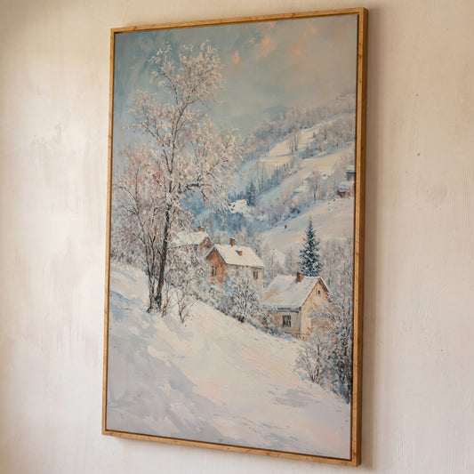 Snowy Village and Mountain Landscape Canvas shown in white oak floating frame