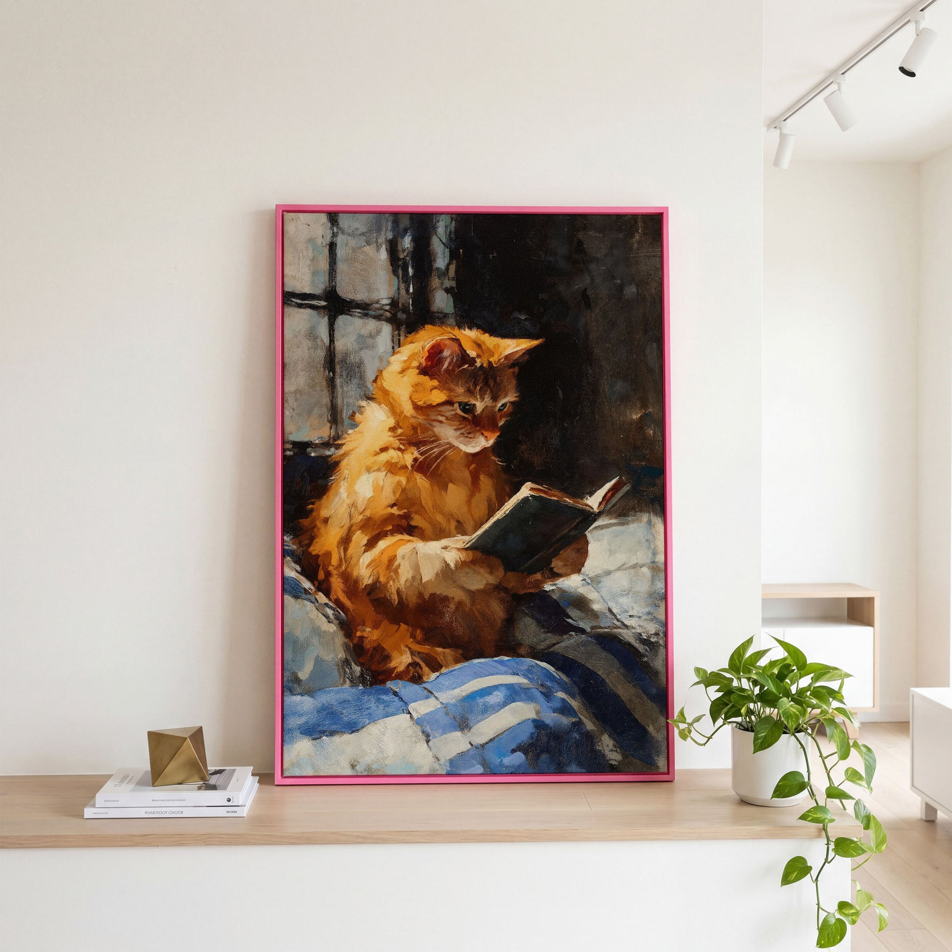 Ginger Cat Reading in Bed Canvas Wall Art in pink floating frame