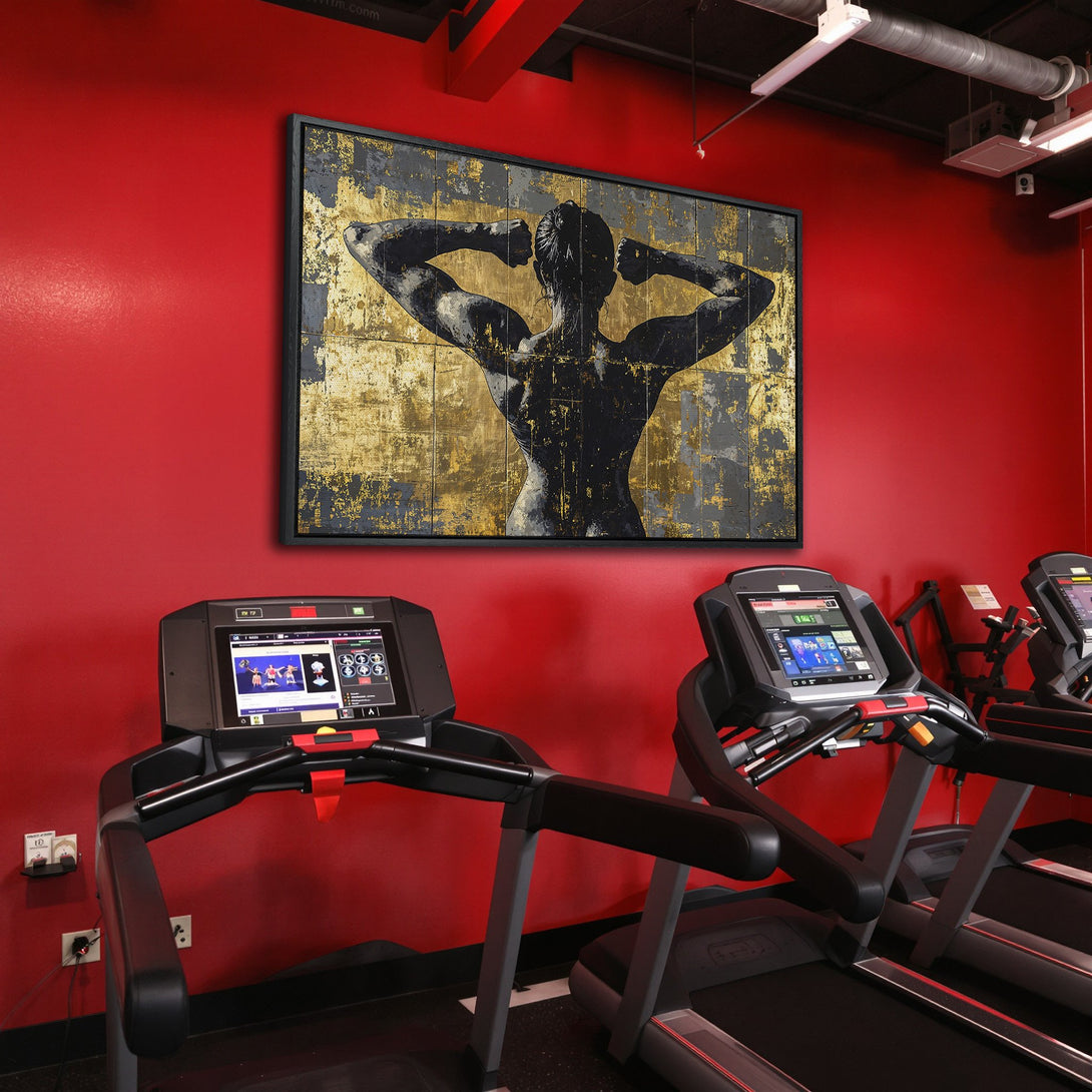 Framed Wall Art: Abstract black and gold figure in a gym setting. Modern art canvas print with a bold red and neutral color palette. Elevate your space!