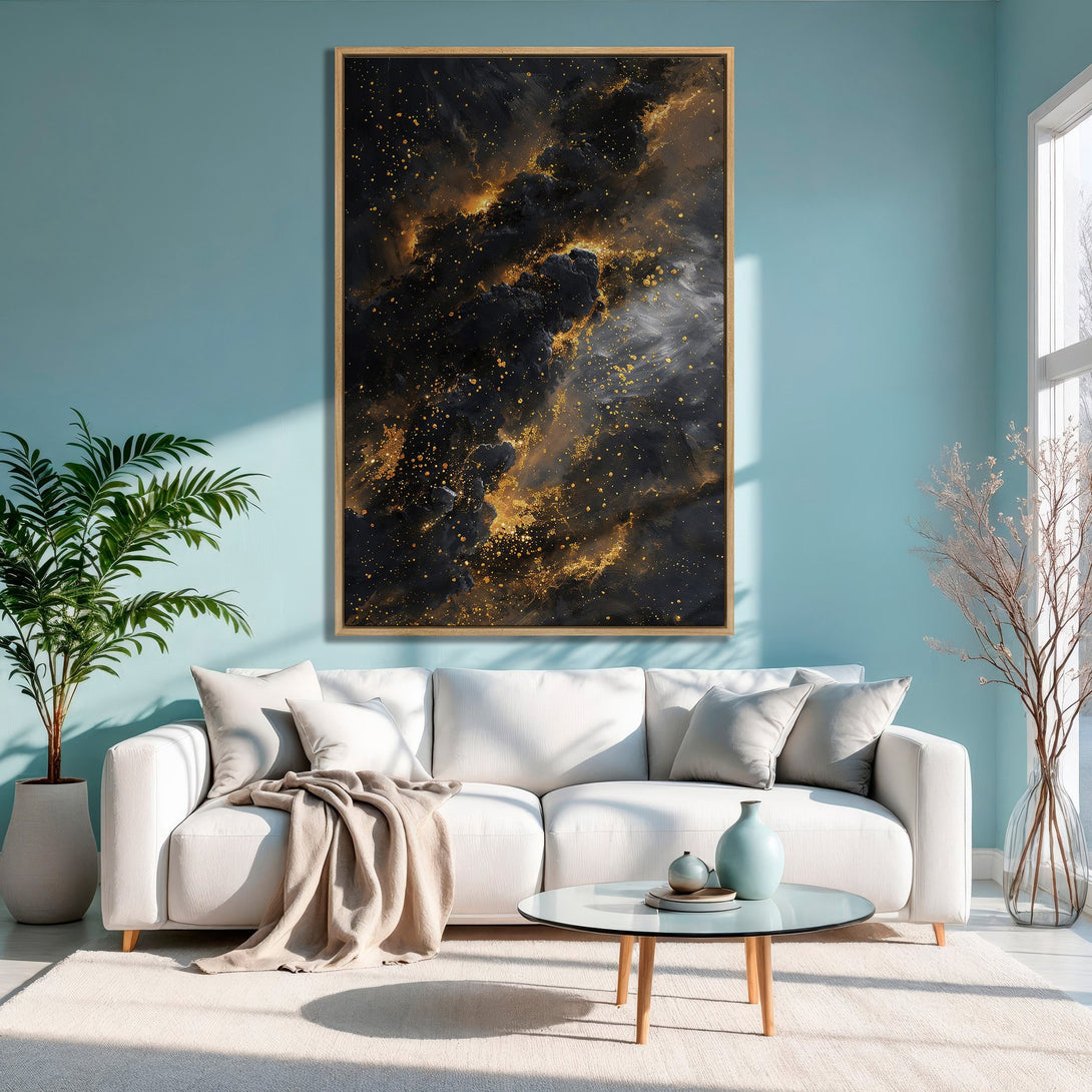 Framed Wall Art: Abstract galaxy canvas print in black and gold, displayed in a modern living room with a teal wall and white sofa.