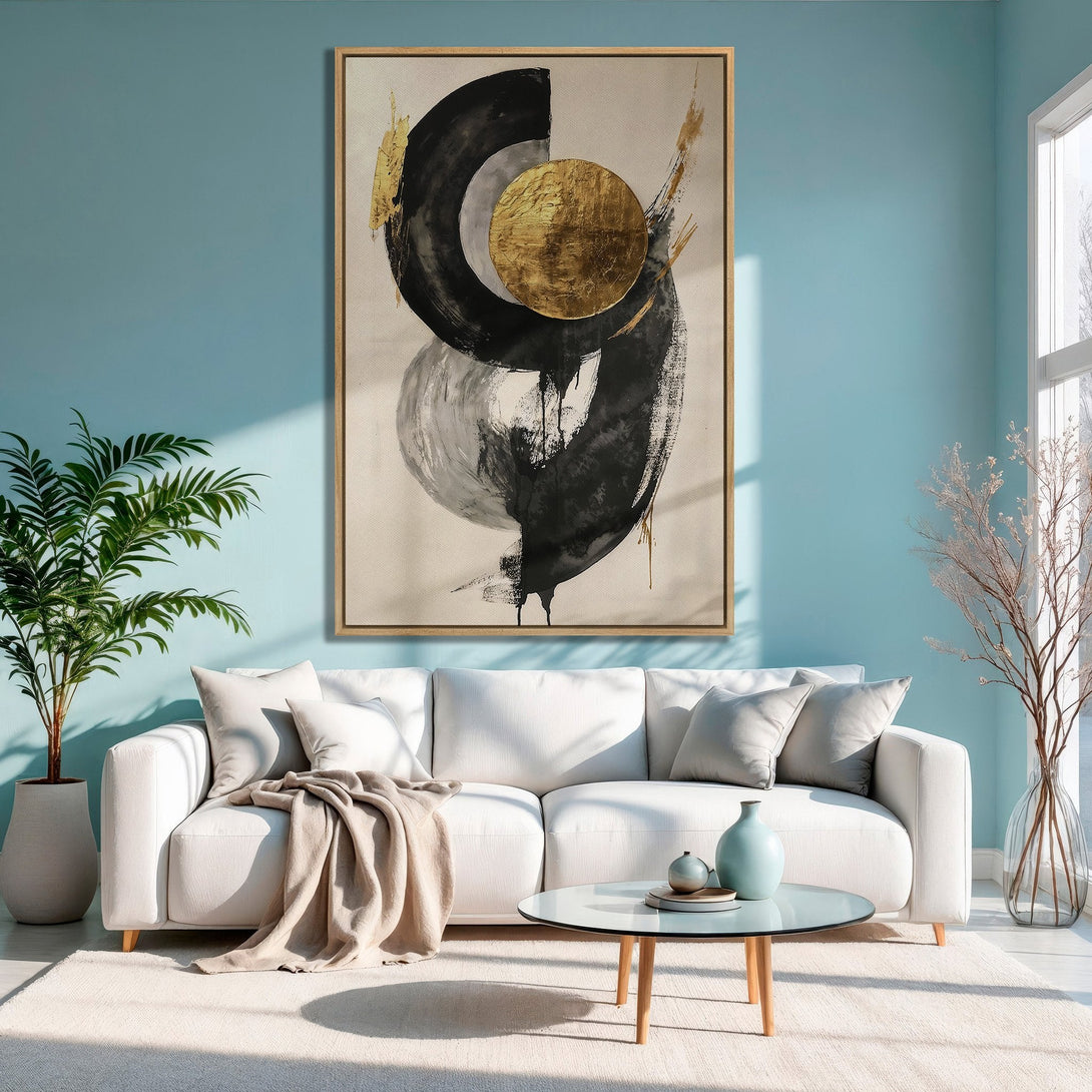 Abstract Canvas Print in a modern living room. Black, gold, and gray art on a light blue wall. Perfect for home decor.