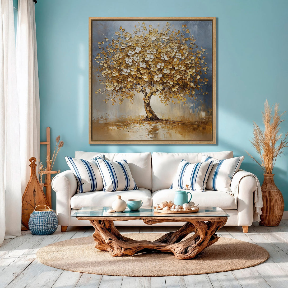 Framed Wall Art: Stunning gold leaf tree painting in a modern living room. Earthy tones and blue accents create a calming, stylish space. Shop our art collection!