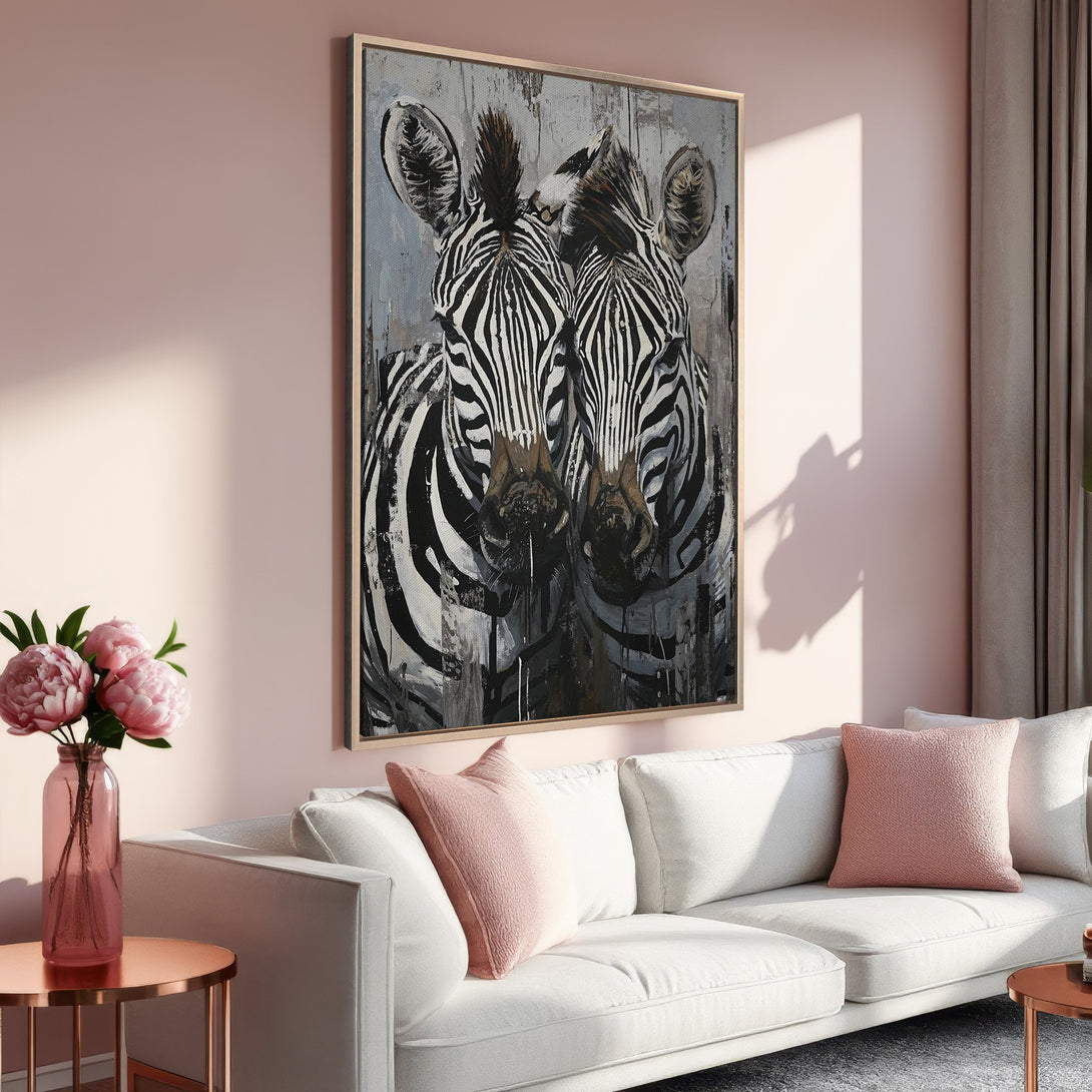 Framed Wall Art featuring a striking zebra painting in a modern style. The artwork uses a black, white, and gray palette, complementing a soft pink interior.