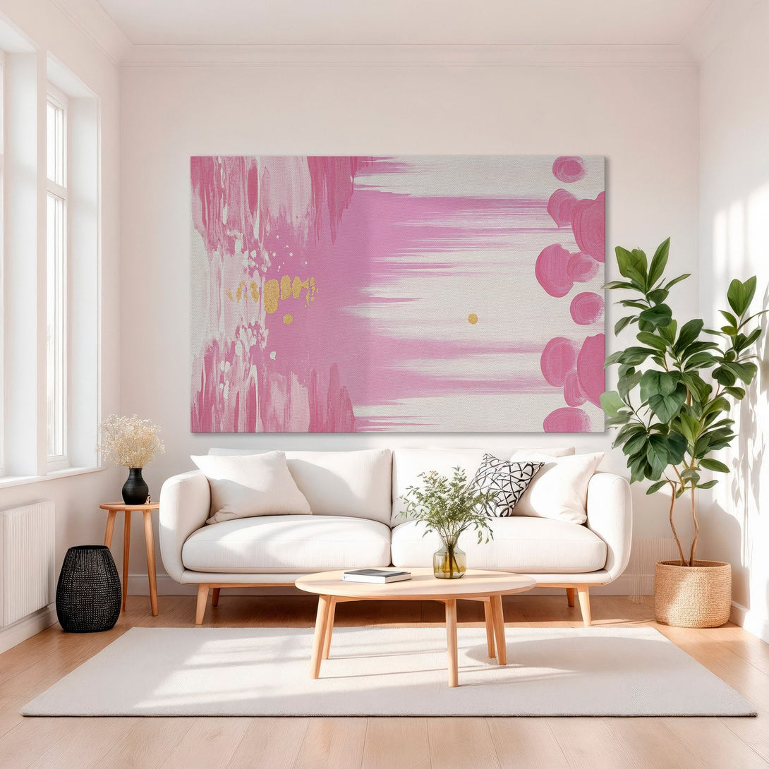 Framed Wall Art: Abstract pink and gold canvas print adds a pop of color to a modern living room. Enhance your space with stylish wall decor!