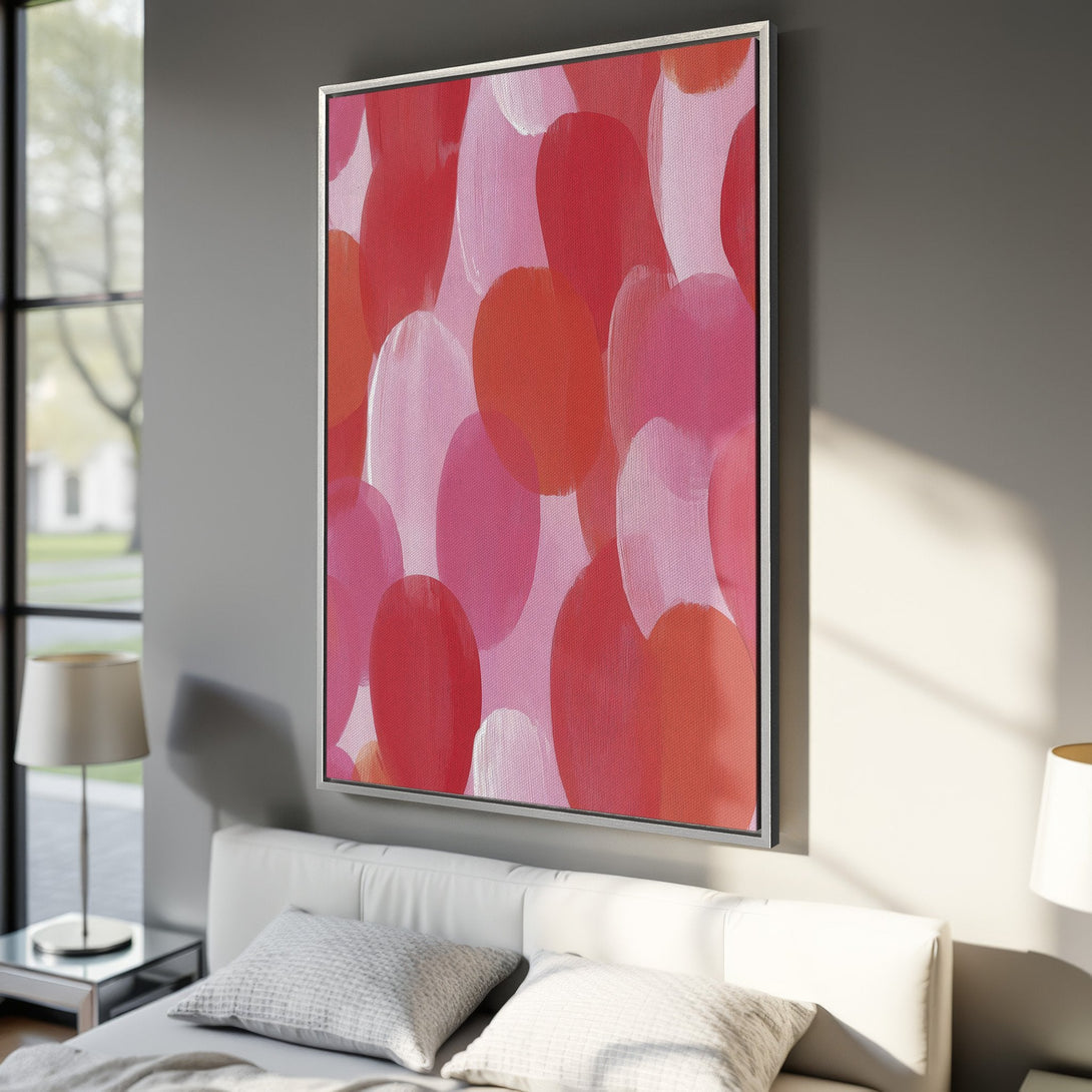 Framed Wall Art: Abstract art Canvas Print in a bedroom. Featuring a vibrant palette of red, pink, and white brushstrokes, adding a pop of color to any space.