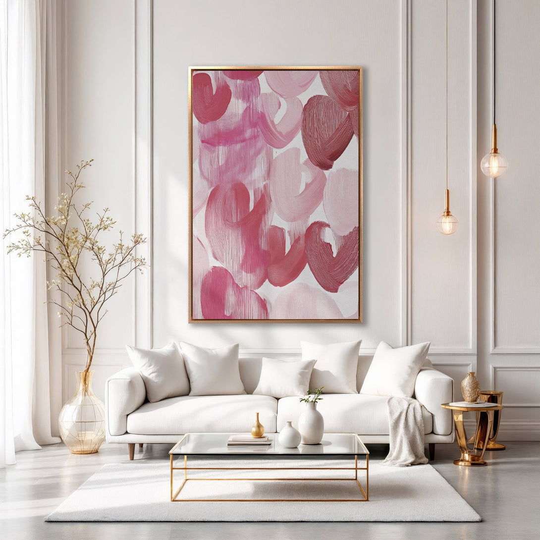 Framed Wall Art: Abstract pink brushstroke art in a gold frame. Modern canvas print with a blush and rose color palette, perfect for a stylish living room.