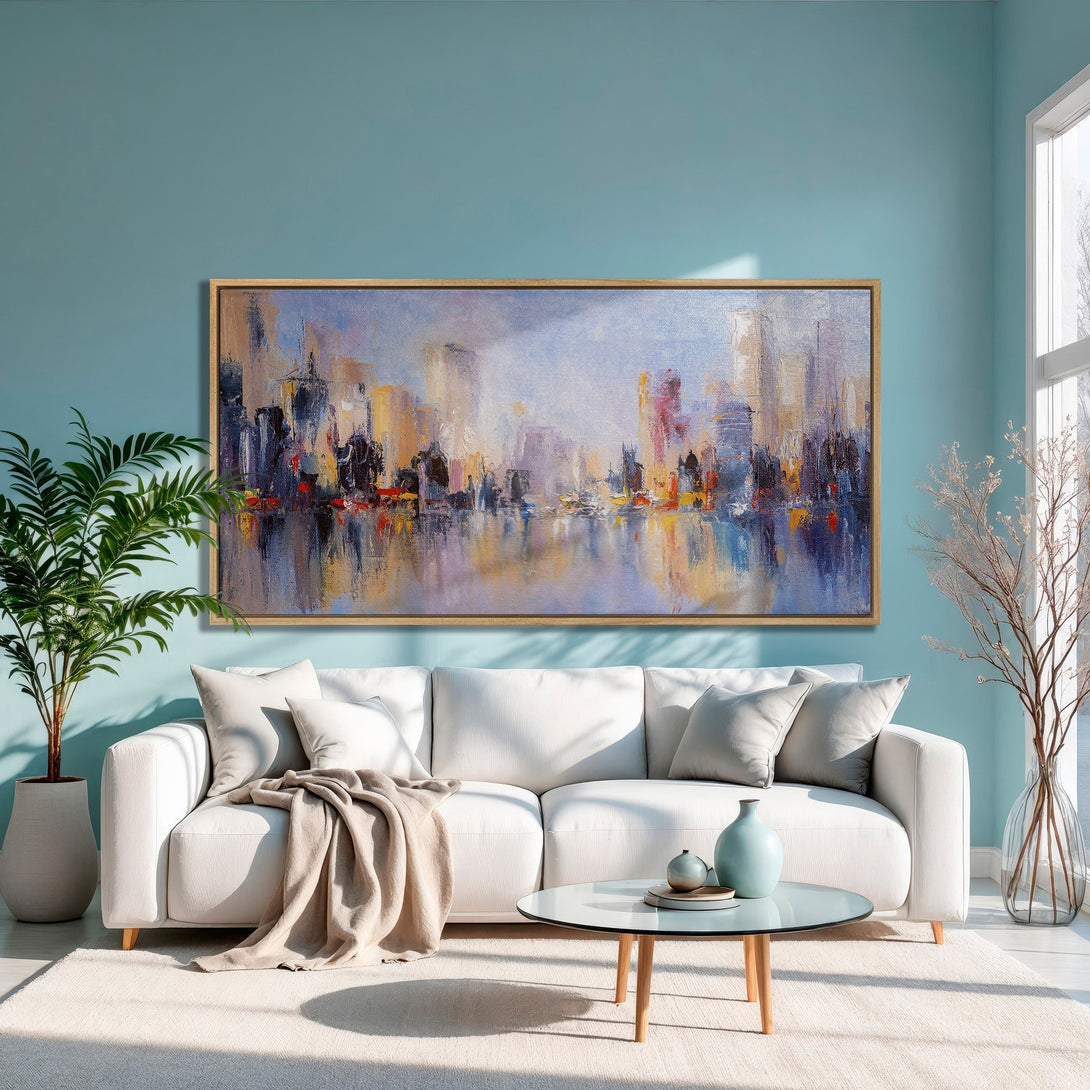 Framed Wall Art: Abstract cityscape canvas print in a modern living room. Features a vibrant palette of blues, oranges, and purples. Perfect for home decor!
