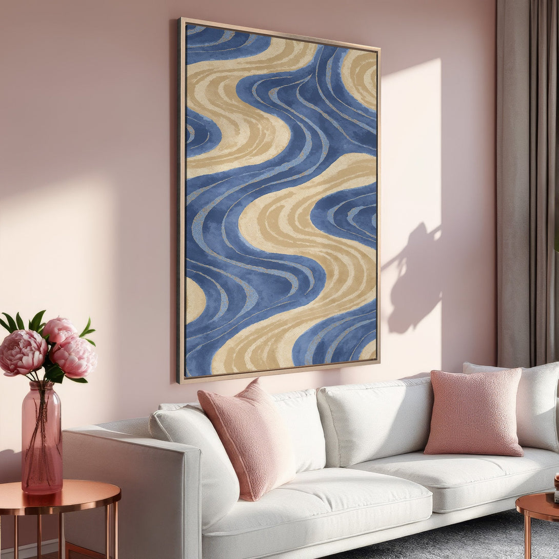 Framed Wall Art: Abstract blue and beige wave design canvas print. Modern art in a stylish living room with a pink and neutral color palette.