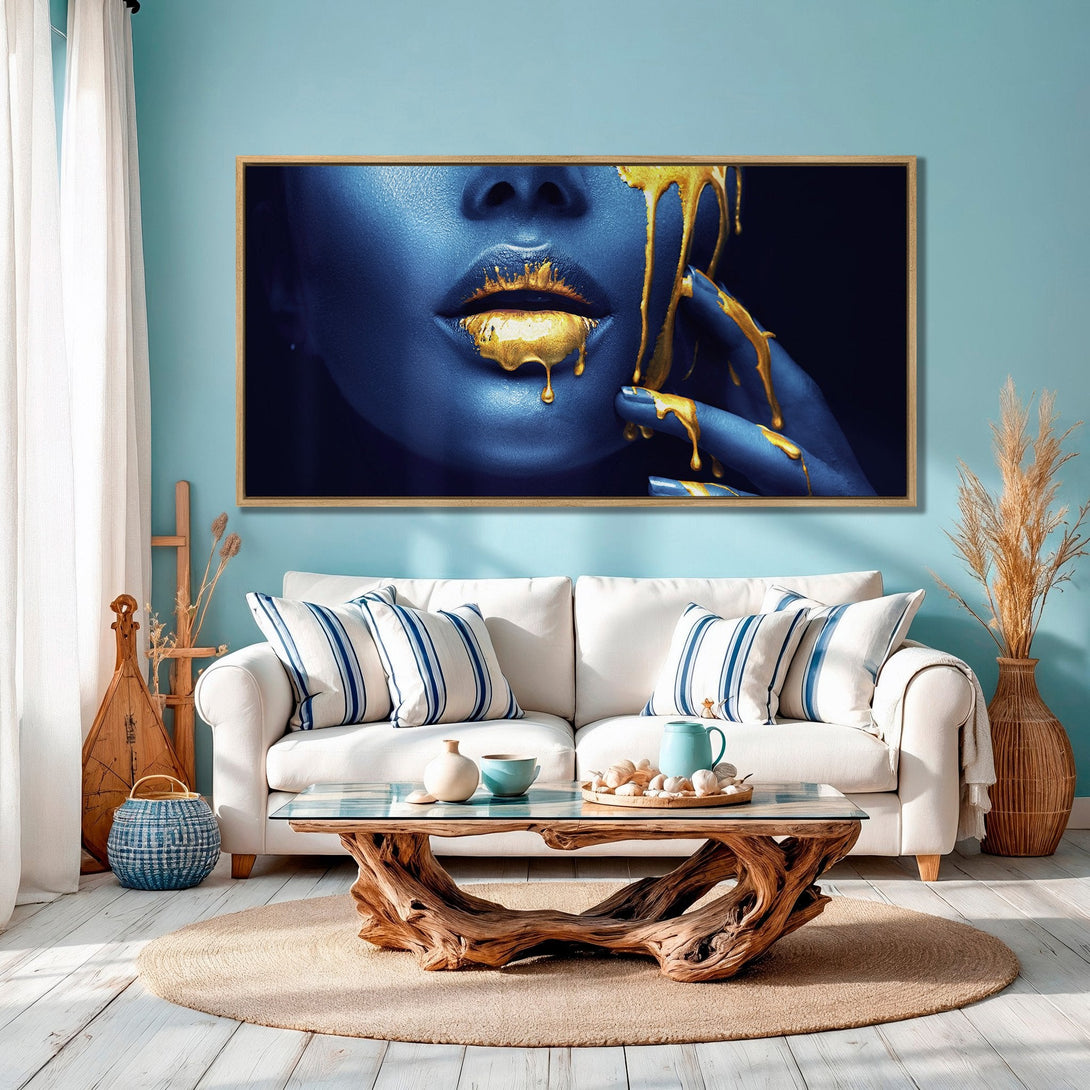 Framed Wall Art featuring a close-up of a face with gold dripping accents. Modern style, blue and gold color palette. Elevate your space!