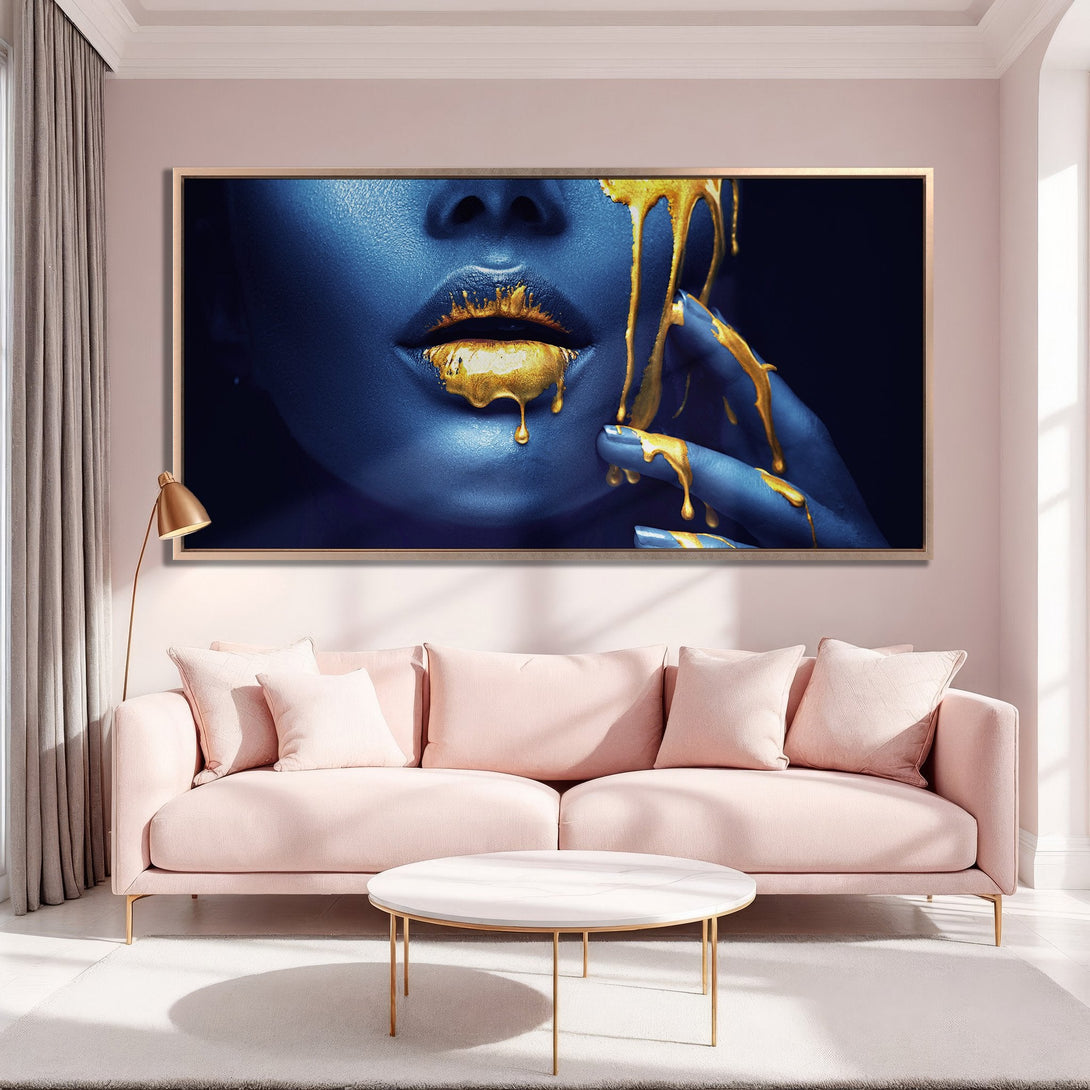 Framed Wall Art: Blue face with gold dripping paint. Modern art print in a pink and gold interior. Elevate your space with this stunning canvas!