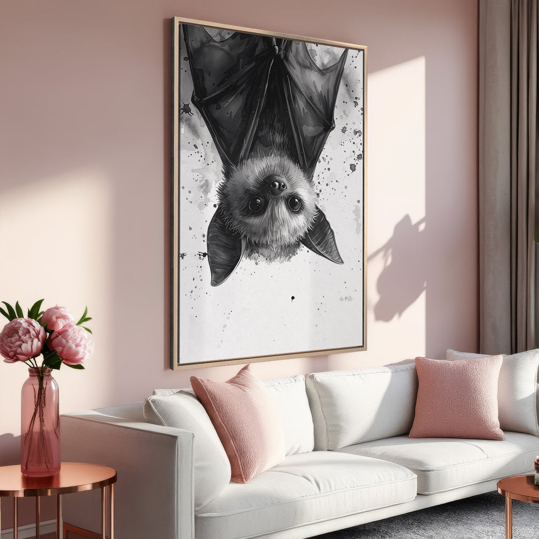 Framed Wall Art featuring a whimsical bat illustration in black and white, perfect for adding a touch of modern art to any space. Soft pink color palette.